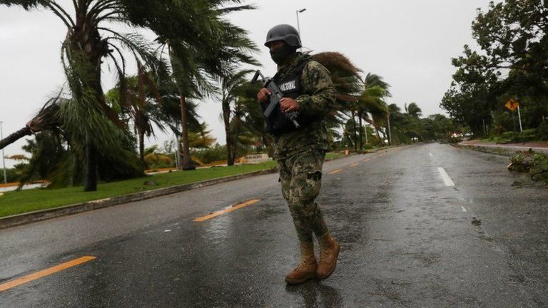 A soldier stands guard along an avenue Tulum after Hurricane Delta hit, in the state of Quintana Roo, in Cancun, Mexico October 7, 2020