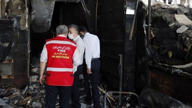 Firefighters inspect scene of a blast at a medical clinic in Tehran (01/07/20)