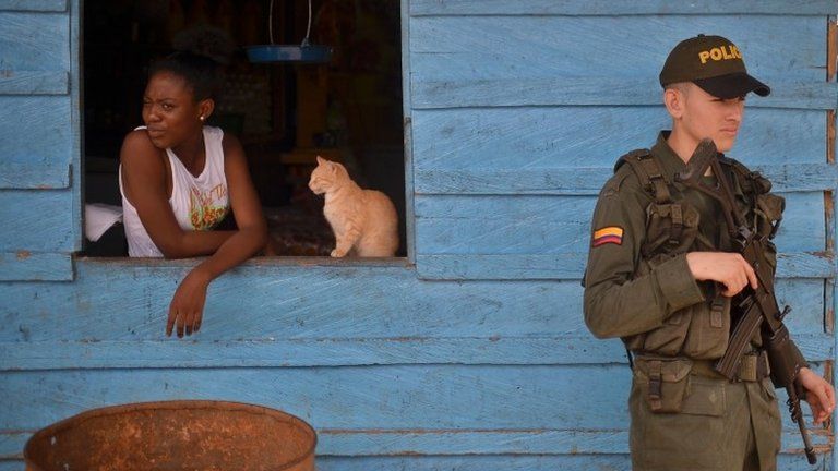 A Colombian police officer guards the streets of the town of Pie de Pato, department of Choco, western Colombia, on January 24, 2017