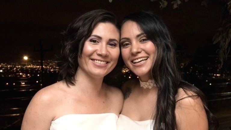 Newlyweds Alexandra Quiros (L) and Dunia Araya (R) pose during their wedding in Heredia, Costa Rica, on May 26, 2020