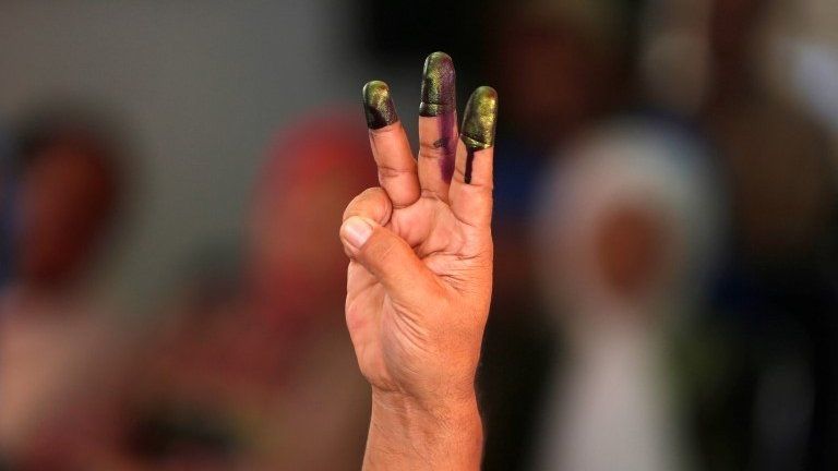 A man shows his fingers after casting his vote in the governor election in Jakarta, Indonesia April 19, 2017.