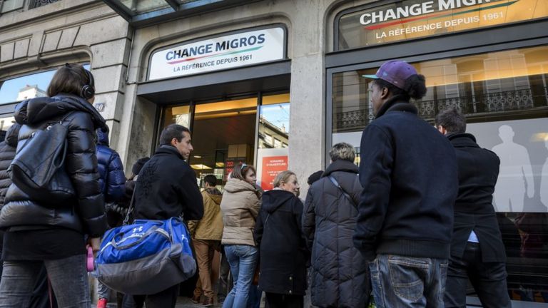 People queue at a bureau de change in Geneve