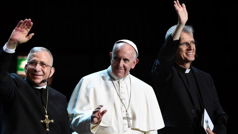 President of the Lutheran World Federation Bishop Munib Younan (L), Pope Francis (C), and General Secretary of the Lutheran World Federation Rev Martin Junge arrive at the Malmo Arena in Sweden for an event (31 October 2016)