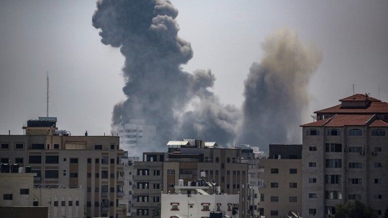 Smoke rise after an Israeli air strike in Gaza City, 16 May 2021.