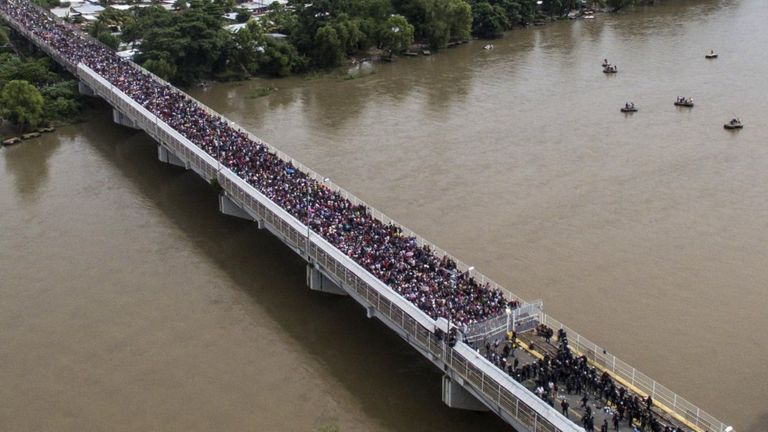 Aerial view of a Honduran migrant caravan heading to the US, as it is stopped at a border barrier on the Guatemala-Mexico international bridge