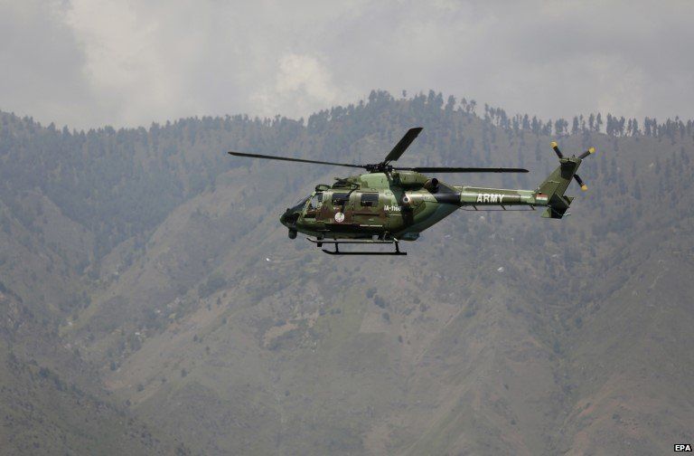 An Indian army helicopter flies above the army base which was attacked by suspected rebels in the town of Uri, west of Srinagar, Indian controlled Kashmir,