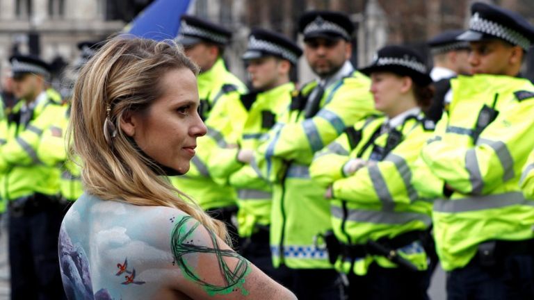 A climate change activist with her body painted demonstrates around Parliament Square during the Extinction Rebellion protest in London, Britain April 23, 2019