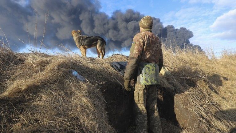 A Ukrainian serviceman stands in a position following a Russian missile attacked near Kyiv