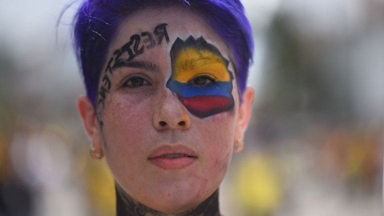 A women participates in a new day of protest against the tax reform as International Workers" Day is commemorated in Cali, Colombia, 01 May 2021