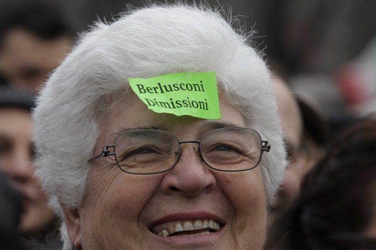 Woman sports a sticky note against Italian premier Silvio Berlusconi reading "Berlusconi resign" during a protest in Milan