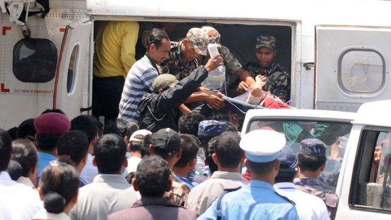 Nepalese rescue personnel transfer an Agni Air plane crash survivor into an ambulance after evacuated to Pokhara Airport, some 200 kms west of Kathmandu, on May 14, 2012