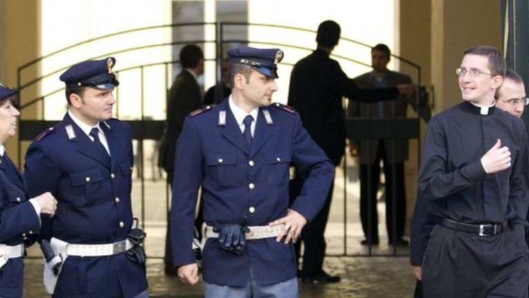 Police officers stand outside Saint Apollinare Basilica, in Rome, 14 May 2012.