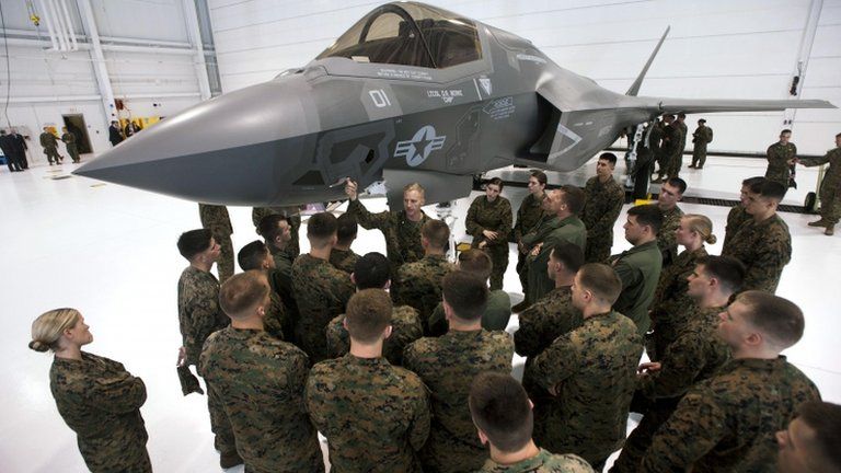 A group of US soldiers are shown an F-35 fighter jet at Eglin Air Force Base, Florida 24 February 2012