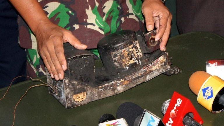 An Indonesian military officer displays the charred black box on 15 May, 2012 of the Russian Sukhoi Superjet 100 that crashed in Mount Salak a week ago