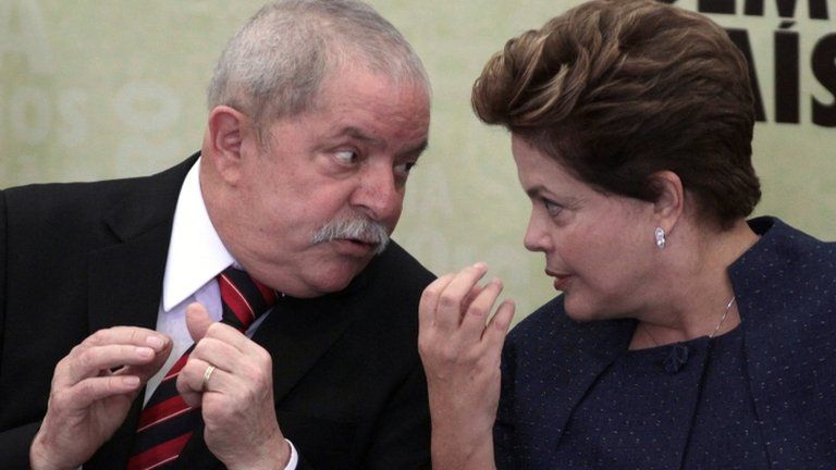 Brazil's President Dilma Rousseff (right) talks to her predecessor Luiz Inacio Lula da Silva during the inauguration of the truth commission