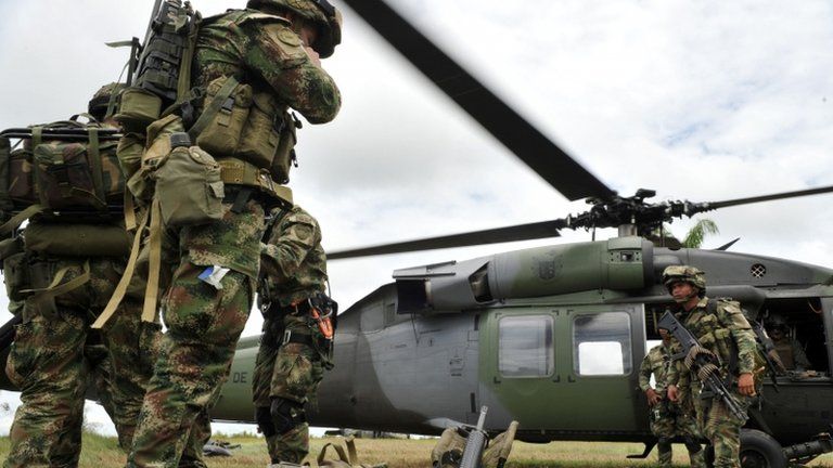 Airborne soldiers board a helicopter in Guerima, in the eastern province of Vichada, eastern plains of Colombia, on March 9, 2011