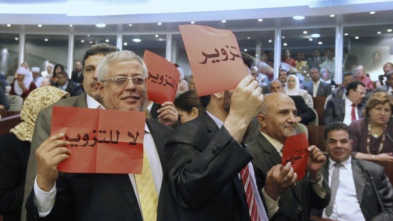 Delegates from the Green Algeria alliance, a grouping of moderate Islamist parties with links to the ruling establishment, hold up placards during the opening session of the new National Assembly in Algiers May 26, 2012