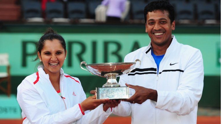 Sania Mirza and Mahesh Bhupathi of India pose with the winners trophy after defeating Klaudia Jans-Ignacik of Poland and Santiago Gonzalez of Mexico in the mixed doubles final during day 12 of the French Open at Roland Garros on June 7, 2012 in Paris, France