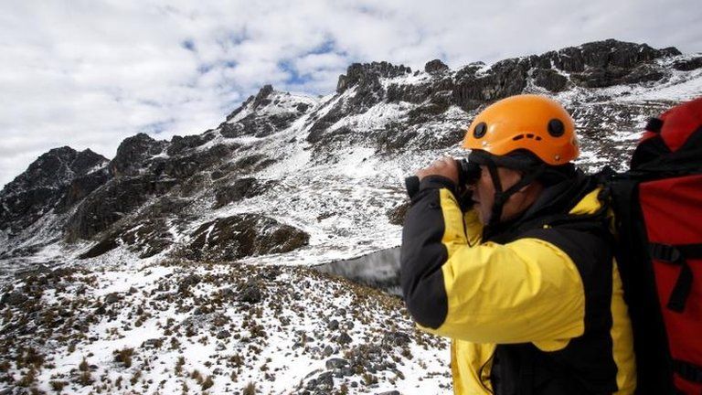 A member of a Peruvian police high mountain rescue team works in the Hualla Hualla area during the ongoing rescue operations