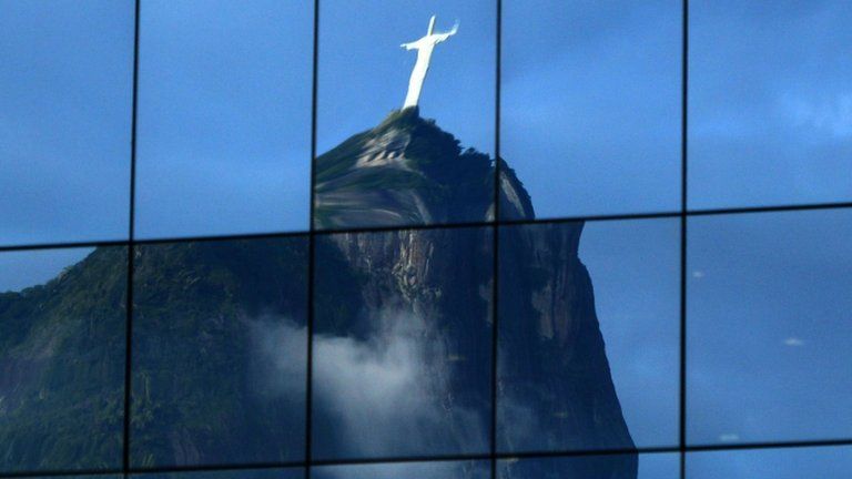 Christ the Redeemer statue reflected in the windows of a business building (15 June 2012)