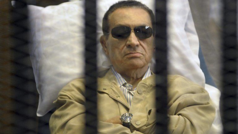 Hosni Mubarak sits inside a cage in a courtroom in Cairo. Photo: 2 June 2012