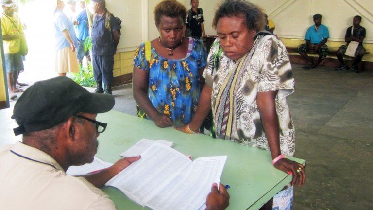 Voters names are checked in Kokopo, East New Britain province, Papua New Guinea, 23 June