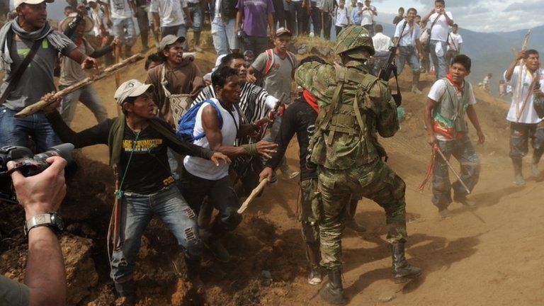 Nasa men threaten a soldier in Cauca province