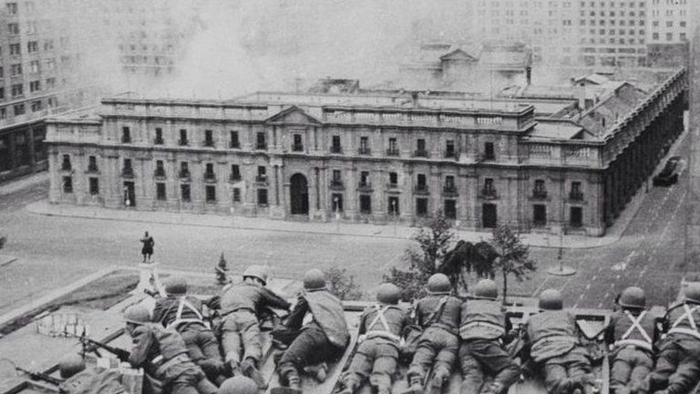 Soldiers supporting the coup led by Gen Augusto Pinochet take cover as bombs are dropped on the Presidential Palace of La Moneda in this 11 September 1973 file photo