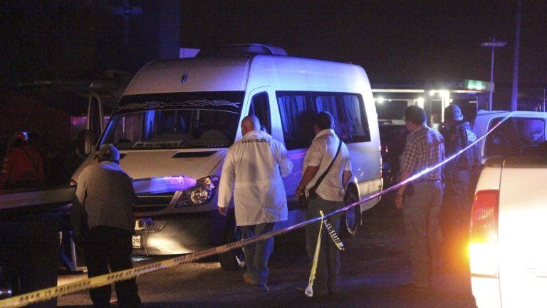 Forensic technicians stand around a white van near San Luis Potosi
