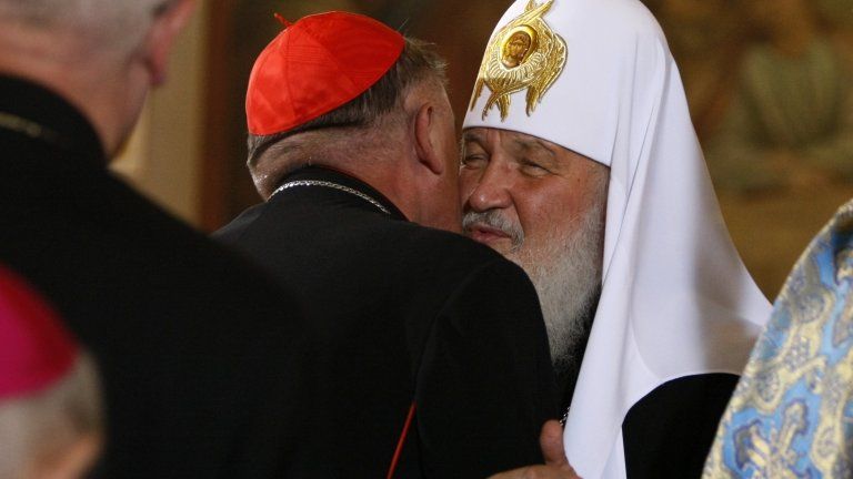 Patriarch Kirill (seen) embraces Polish Cardinal Kazimierz Nycz in Warsaw, 16 August
