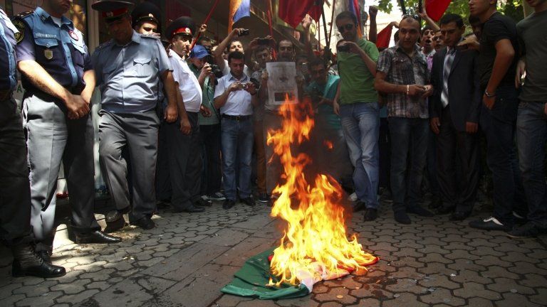 Armenian protesters burn a Hungarian national flag outside the Hungarian consulate in Yerevan. Photo: 1 September 2012