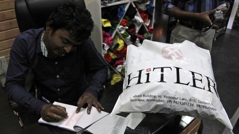 Rajesh Shah, one of the owners of the Hitler store, prepares a bill for a customer in Ahmadabad, India, Wednesday, Aug. 29, 2012.