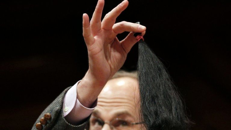 Raymond Goldstein holds a ponytail