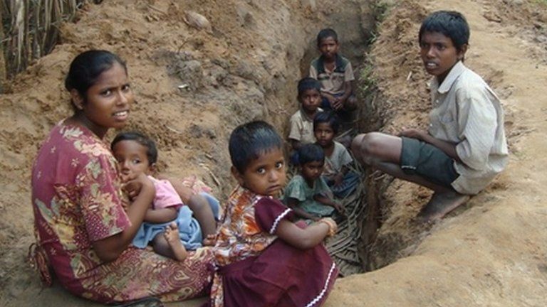 A family seeking shelter from shelling in a trench in Sri Lanka during the civil war