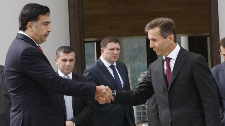 Mikheil Saakashvili (left) shakes hands with Bidzina Ivanishvili in Tbilisi, 9 October