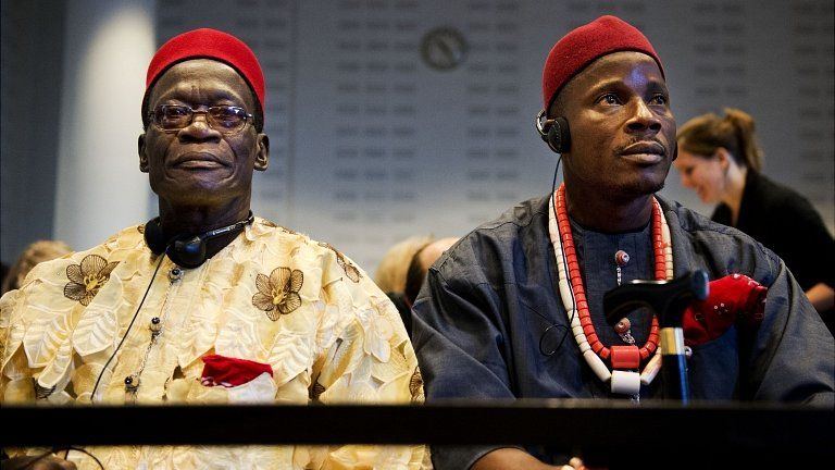 Nigerian farmers Chief Fidelis A Oguru-Oruma and Eric Dooh sit in the law court in The Hague. 11 Oct 2012
