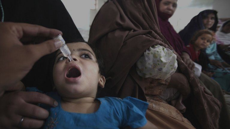 A Pakistani medic gives a polio vaccine to a child in Peshawar, Pakistan, Monday, Sept. 10, 2012