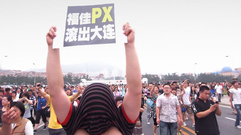 This photo taken on August 14, 2011 shows a protester holding up a sign as hundreds of people demonstrate over the Fujia chemical plant in Dalian, in northeast China's Liaoning province.