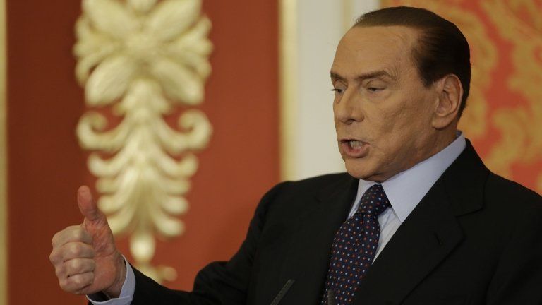 Former Italian Premier Silvio Berlusconi talks during a press conference in Gerno, near Milan, on 27 October.