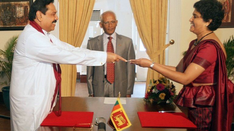 This handout photo taken on May 18, 2011 and released by Sri Lanka"s Presidential Secretariat shows President Mahinda Rajapakse (L) presenting a letter of appointment to Shirani Bandaranayake who became Sri Lanka"s first woman chief justice.
