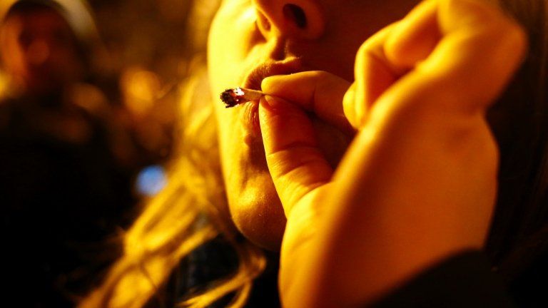 A woman smokes marijuana in Seattle on Tuesday 6 November