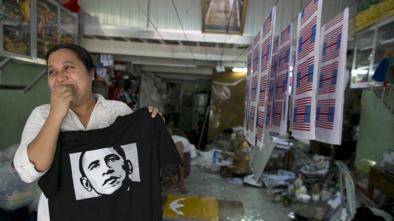 Kyu Kyu Mar, owner of Super silk screening shop, holds a T-shirt printed with an image of US President Barack Obama in Rangoon, Burma, 16 November 2012