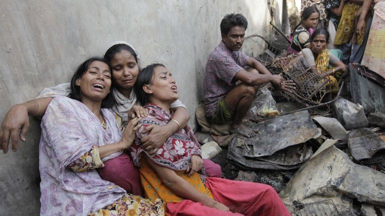 residents of the slum outside Dhaka mourn the dead
