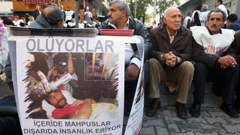 Members of a pro-Kurdish party sit as they start a two-day hunger strike to support several hundreds Kurdish inmates who are on a hunger strike in jails for 67 days, in Ankara
