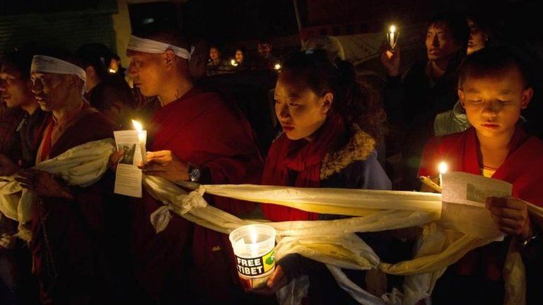 Tibetan exiles participate in a candlelit vigil in solidarity in Dharmsala, India, after reports of a self-immolation in northwestern China's Gansu province, 13 Oct 2012