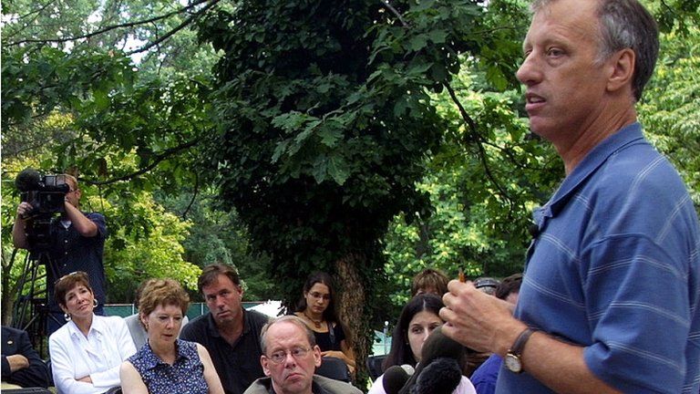 Eric Olson answers questions outside his home in Frederick, Maryland August 2002