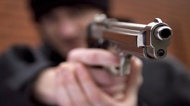 Generic image of man holding a gun