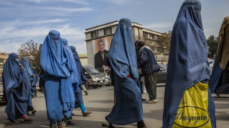 Afghan women walk through the street in Kabul