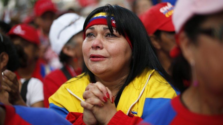 A Chavez supporter prays for his good health in Caracas on 9 December
