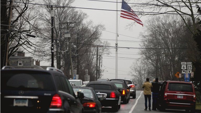 A funeral procession follows the hearse carrying the casket of Sandy Hook Elementary School shooting victim, Jack Pinto, 6, 17 December 2012